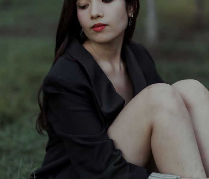 Person sitting in a calm meditative pose with a serene expression.